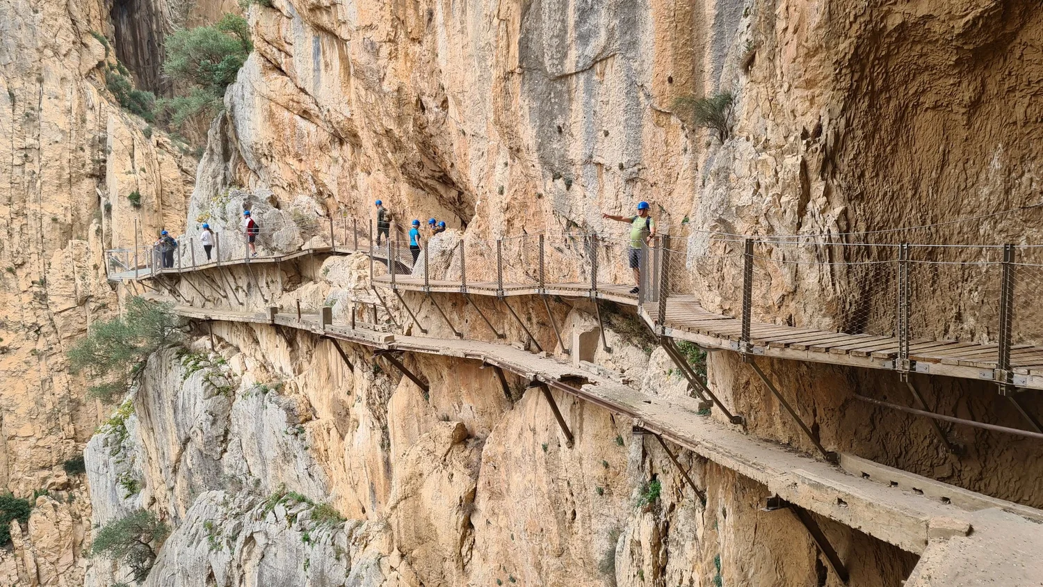 The Caminito del Rey boardwalk pinned to vertical limestone cliffs above a turquoise river gorge at El Chorro, inland Andalucía