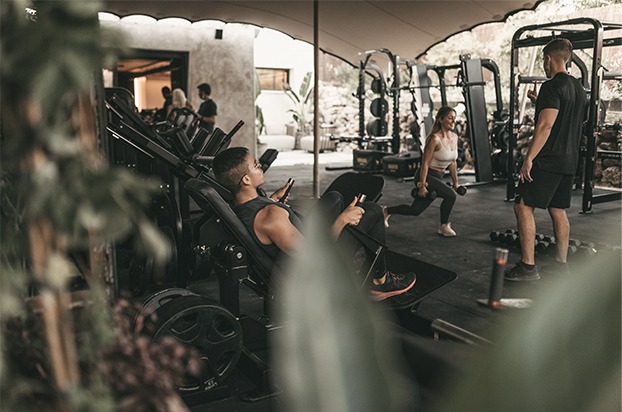 Outdoor training area at The I/O Marbella with open-air strength equipment surrounded by Mediterranean greenery